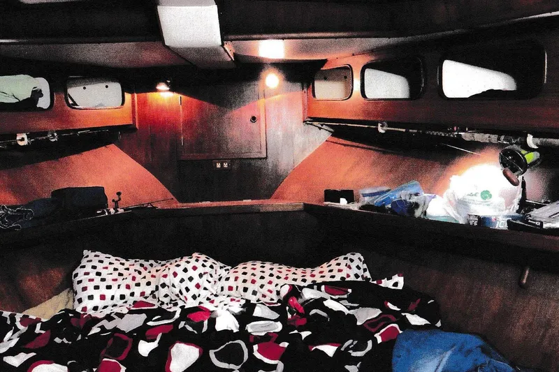 Slide: The Image of Cozy cabin interior of 1984 President D/C Motoryacht with patterned bedding and warm lighting. - 7