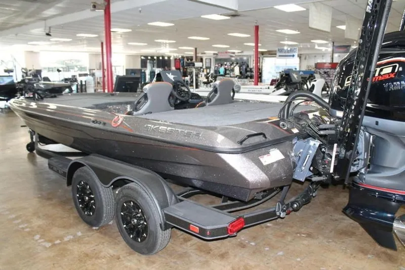 Slide: The Image of 2026 Skeeter ZXE21 boat in showroom, featuring sleek design and dual axle trailer. - 4