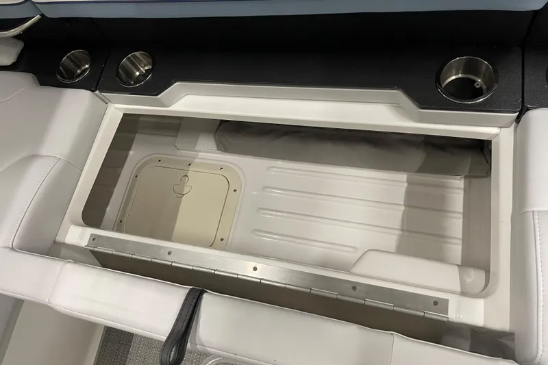 Slide: The Image of 2022 Formula 350 Crossover Bowrider storage compartment with cup holders and sleek design. - 20