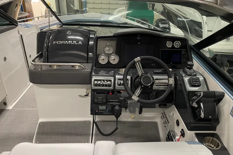 Slide: The Image of 2022 Formula 350 Crossover Bowrider cockpit with modern controls and steering wheel. - 26