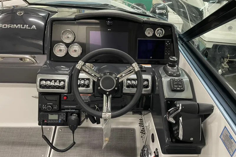 Slide: The Image of 2022 Formula 350 Crossover Bowrider dashboard with steering wheel and control panel. - 27