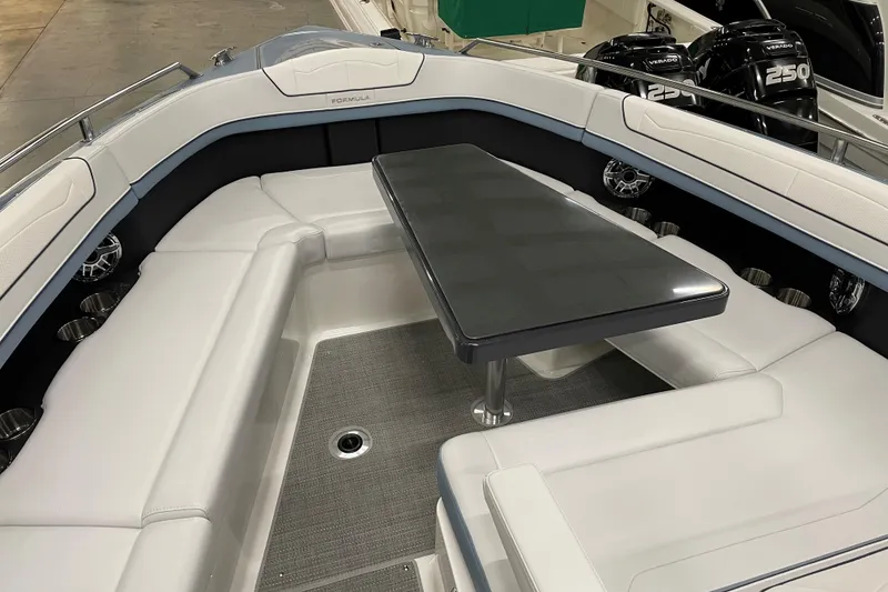 Slide: The Image of 2022 Formula 350 Crossover Bowrider interior with sleek seating and table setup. - 37