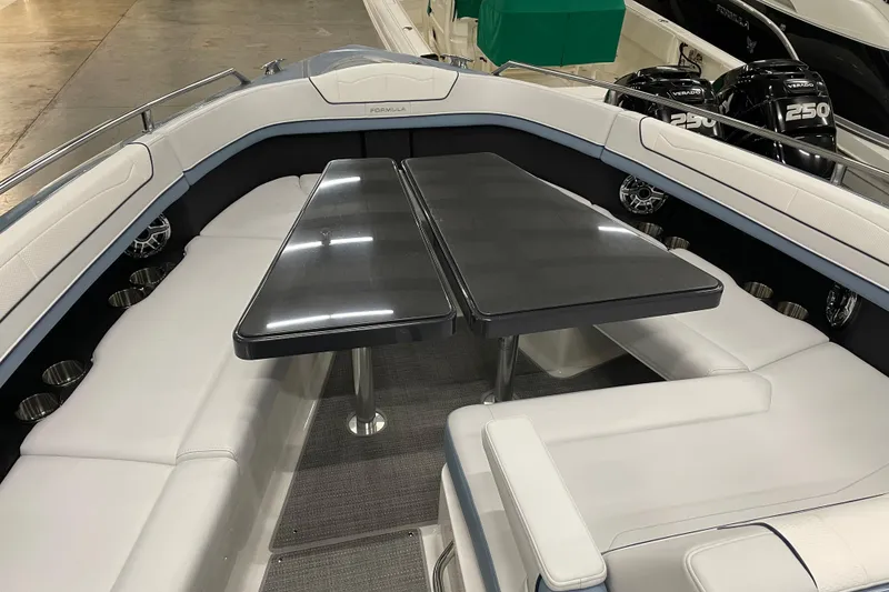 Slide: The Image of 2022 Formula 350 Crossover Bowrider interior with sleek seating and table setup. - 38
