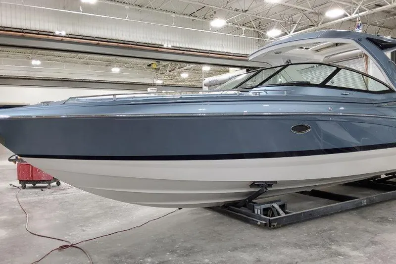 Slide: The Image of 2022 Formula 350 Crossover Bowrider in a showroom, showcasing sleek design and modern features. - 5