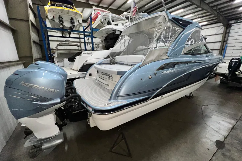 Slide: The Image of 2022 Formula 350 Crossover Bowrider with Mercury engine in a storage facility. - 6