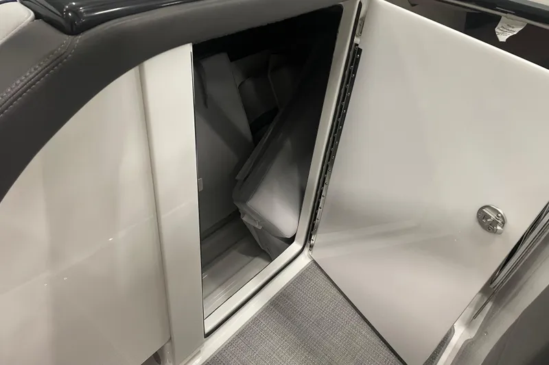 Slide: The Image of 2022 Formula 350 Crossover Bowrider storage compartment with open door, showcasing interior space. - 61