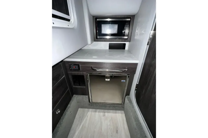 Slide: The Image of 2022 Formula 350 Crossover Bowrider interior with microwave and compact fridge. - 63
