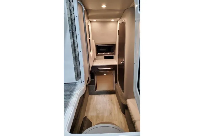 Slide: The Image of 2022 Formula 350 Crossover Bowrider interior with modern kitchenette and seating area. - 65