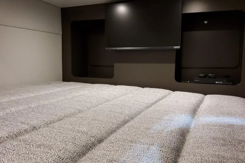 Slide: The Image of 2022 Formula 350 Crossover Bowrider cabin with TV and comfortable bedding. - 67