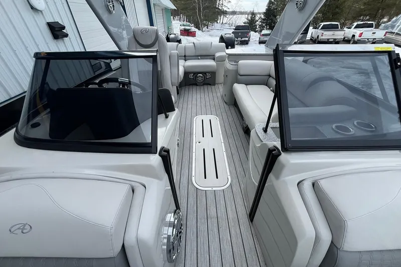 Slide: The Image of 2018 Avalon Excalibur Elite Windshield 27' boat interior with luxurious seating and sleek design. - 11