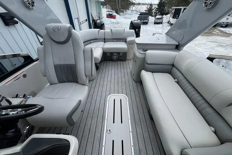 Slide: The Image of 2018 Avalon Excalibur Elite Windshield 27' boat interior with luxurious gray seating. - 12