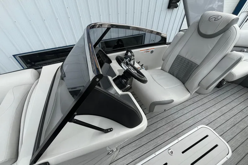 Slide: The Image of 2018 Avalon Excalibur Elite Windshield 27' boat interior with sleek design and modern controls. - 13