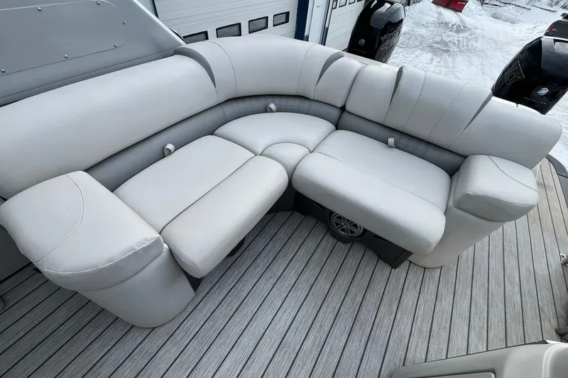 Slide: The Image of Luxurious seating on 2018 Avalon Excalibur Elite Windshield 27' boat, featuring plush gray upholstery. - 15