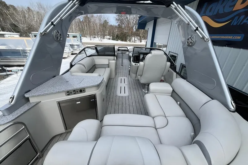Slide: The Image of Luxurious 2018 Avalon Excalibur Elite Windshield boat interior with plush seating and modern amenities. - 20