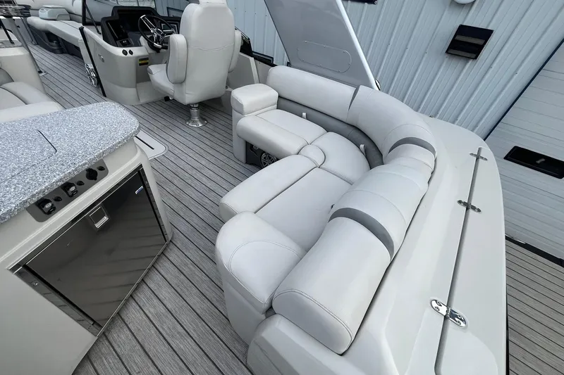Slide: The Image of Luxurious interior of 2018 Avalon Excalibur Elite Windshield boat with plush seating and modern amenities. - 21