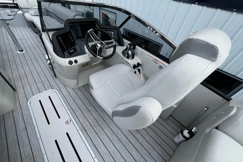 Slide: The Image of 2018 Avalon Excalibur Elite Windshield boat interior with sleek captain's chair and modern dashboard. - 23