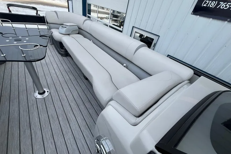 Slide: The Image of 2018 Avalon Excalibur Elite Windshield 27' boat interior with sleek seating and modern table design. - 28