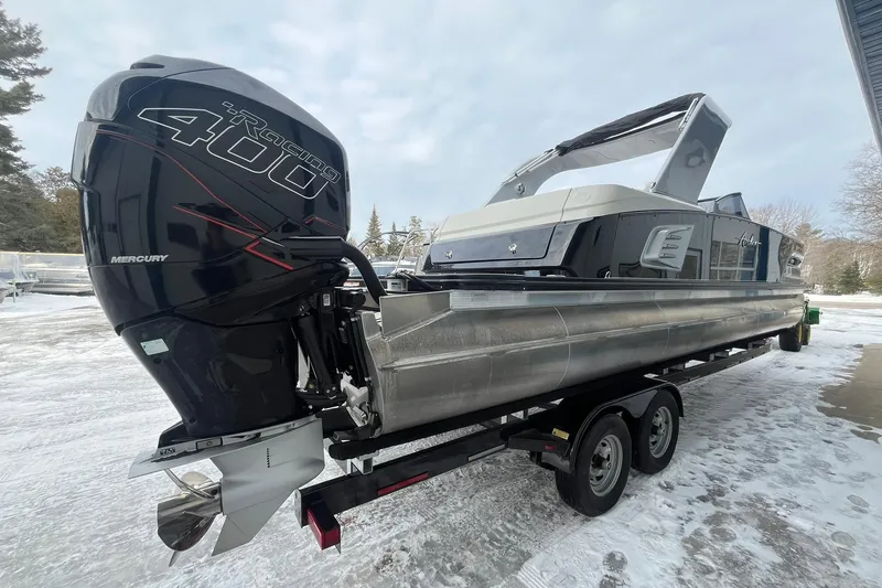 Slide: The Image of 2018 Avalon Excalibur Elite Windshield 27' boat with Mercury Racing 400 engine on trailer. - 4