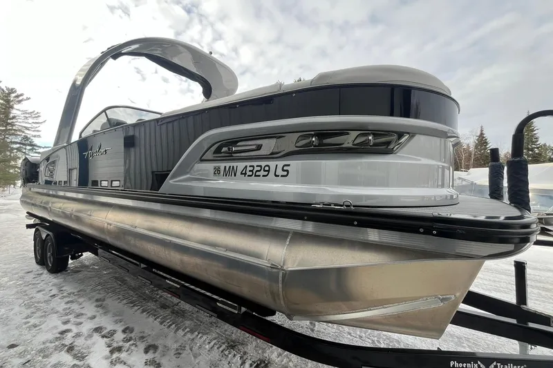 Slide: The Image of 2018 Avalon Excalibur Elite Windshield 27' pontoon boat on trailer in snowy setting. - 5