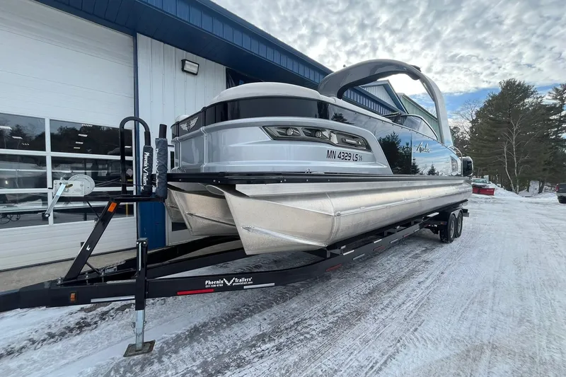 Slide: The Image of 2018 Avalon Excalibur Elite Windshield 27' pontoon boat on trailer, snowy outdoor setting. - 7
