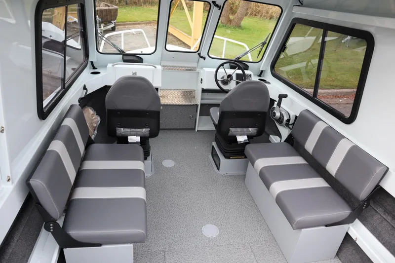 Slide: The Image of 2025 Hewescraft 200 ProV ET HT boat interior with gray seating and steering console. - 12