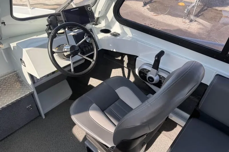 Slide: The Image of 2025 Hewescraft 200 ProV ET Hardtop boat interior with steering wheel and control panel. - 15