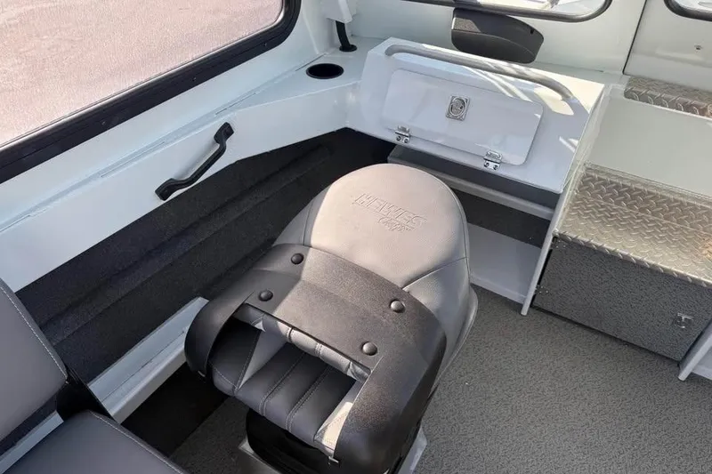 Slide: The Image of 2025 Hewescraft 200 ProV ET Hardtop interior with seating and storage compartments. - 16