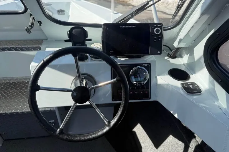 Slide: The Image of 2025 Hewescraft 200 ProV ET Hardtop boat dashboard with steering wheel and navigation system. - 17