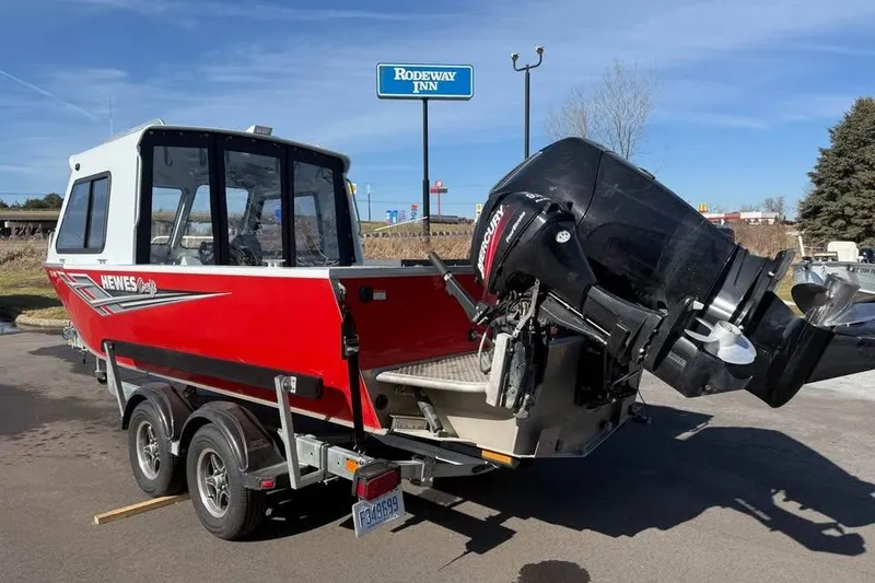 Slide: The Image of 2025 Hewescraft 200 ProV ET Hardtop boat on trailer, parked near Rodeway Inn. - 5