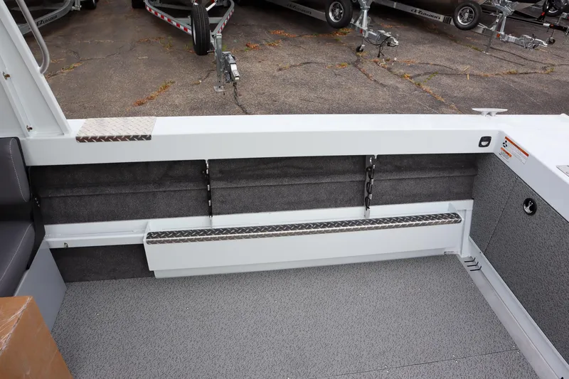 Slide: The Image of 2025 Hewescraft 200 ProV ET HT boat interior with gray flooring and storage compartments. - 7