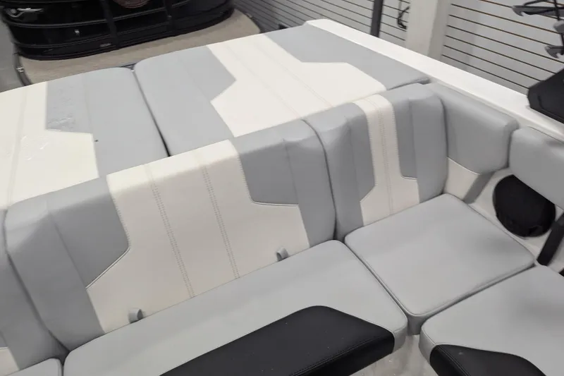 Slide: The Image of 2026 Malibu Wakesetter 21 LX interior seating, featuring gray and white upholstery. - 10