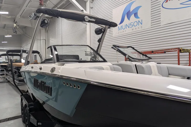 Slide: The Image of 2026 Malibu Wakesetter 21 LX boat in showroom, featuring sleek design and modern amenities. - 3