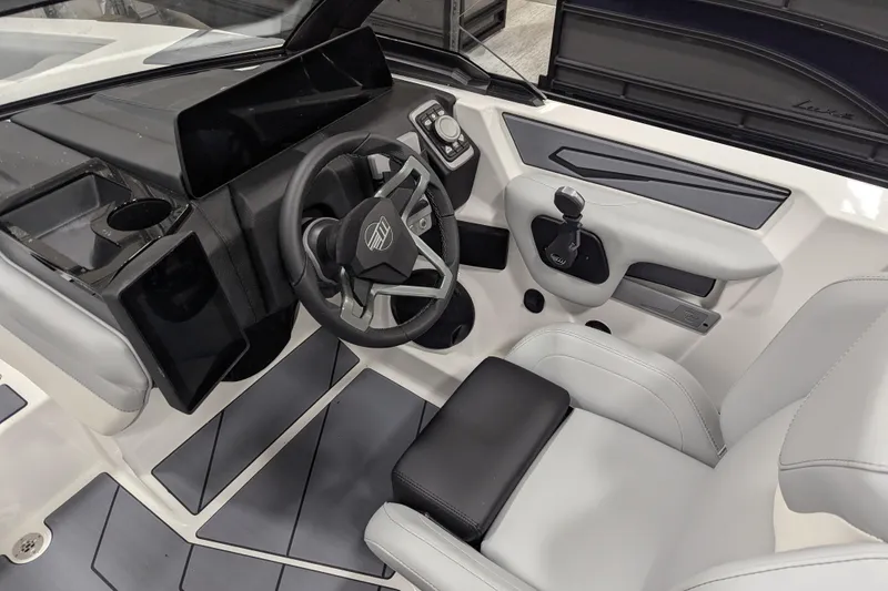 Slide: The Image of 2026 Malibu Wakesetter 21 LX interior with modern steering and control panel. - 7