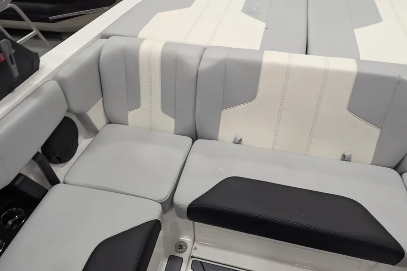 Slide: The Image of 2026 Malibu Wakesetter 21 LX interior seating with gray and white upholstery. - 9