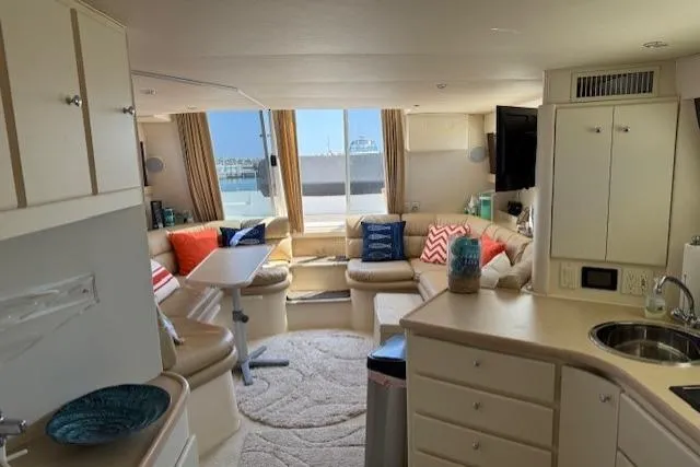 Slide: The Image of Interior of 1999 Carver 380 Santego yacht with cozy seating and modern amenities. - 12