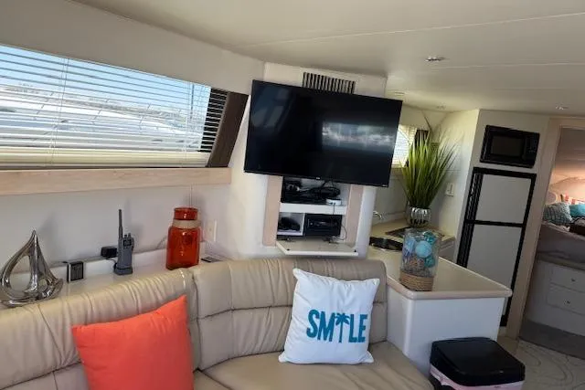 Slide: The Image of Interior of 1999 Carver 380 Santego yacht with modern decor and entertainment setup. - 13