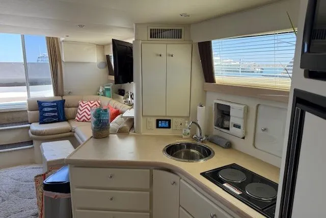 Slide: The Image of Interior of 1999 Carver 380 Santego yacht with modern kitchen and cozy seating area. - 15