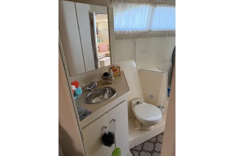 Slide: The Image of Bathroom interior of 1999 Carver 380 Santego yacht, featuring sink, toilet, and mirror. - 16