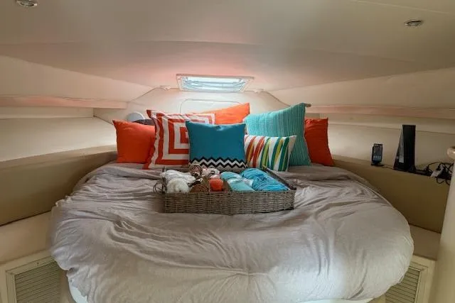 Slide: The Image of Cozy cabin interior of 1999 Carver 380 Santego with colorful pillows and bedding. - 4