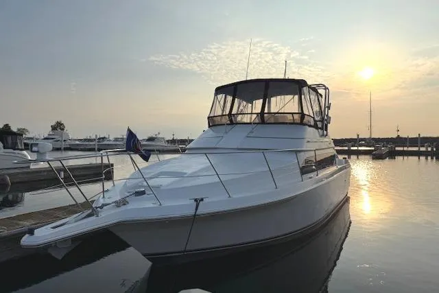 Slide: The Image of 1999 Carver 380 Santego yacht docked at sunset in a marina. - 5