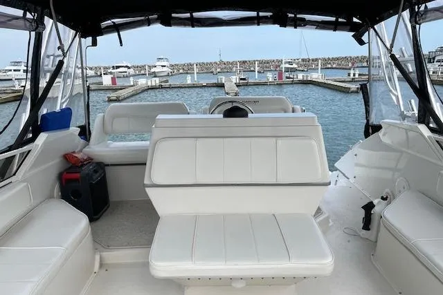 Slide: The Image of 1999 Carver 380 Santego yacht interior with white seating, docked at marina. - 9