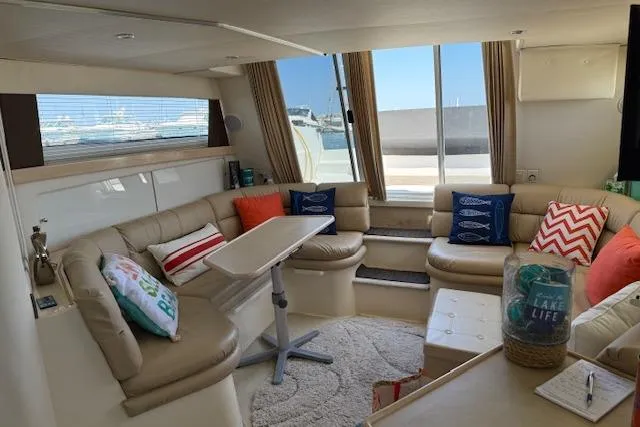 Slide: The Image of Luxurious interior of 1999 Carver 380 Santego yacht with plush seating and nautical decor. - 11