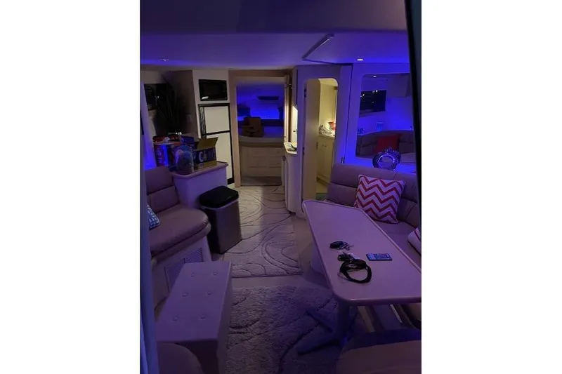Slide: The Image of Interior of 1999 Carver 380 Santego yacht with modern furnishings and ambient lighting. - 17