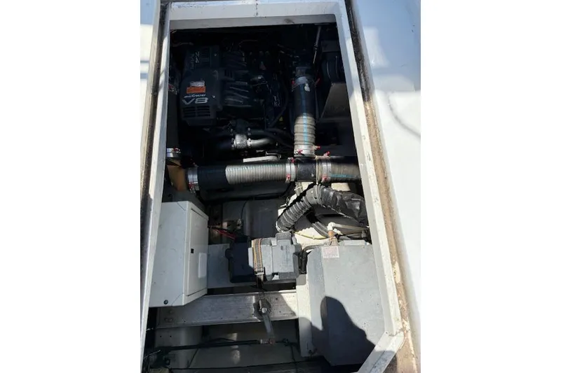 Slide: The Image of Engine compartment of a 1999 Carver 380 Santego boat, showcasing mechanical components. - 19