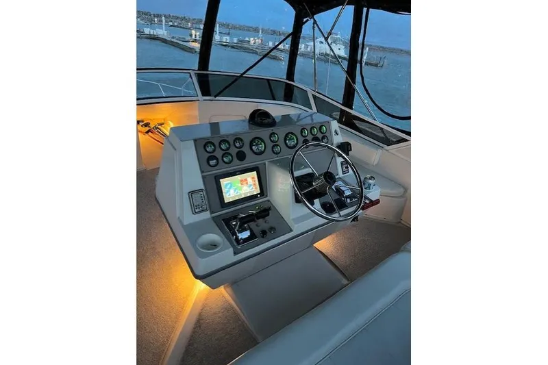 Slide: The Image of 1999 Carver 380 Santego helm with illuminated dashboard and steering wheel at dusk. - 2