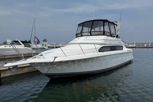 Slide: The Image of 1999 Carver 380 Santego yacht docked in a marina, featuring sleek white design. - 23