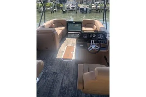 Slide: The Image of 2026 Godfrey Sweetwater 2286 SFL pontoon boat interior with plush seating and modern dashboard. - 4