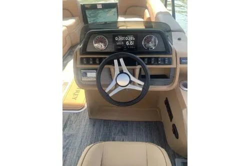 Slide: The Image of 2026 Godfrey Sweetwater 2286 SFL boat dashboard with modern steering and digital display. - 5