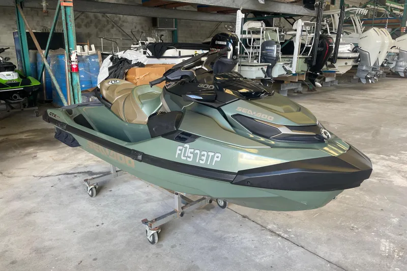 Slide: The Image of 2023 Sea-Doo GTX Limited 300 jet ski in a storage facility. - 0