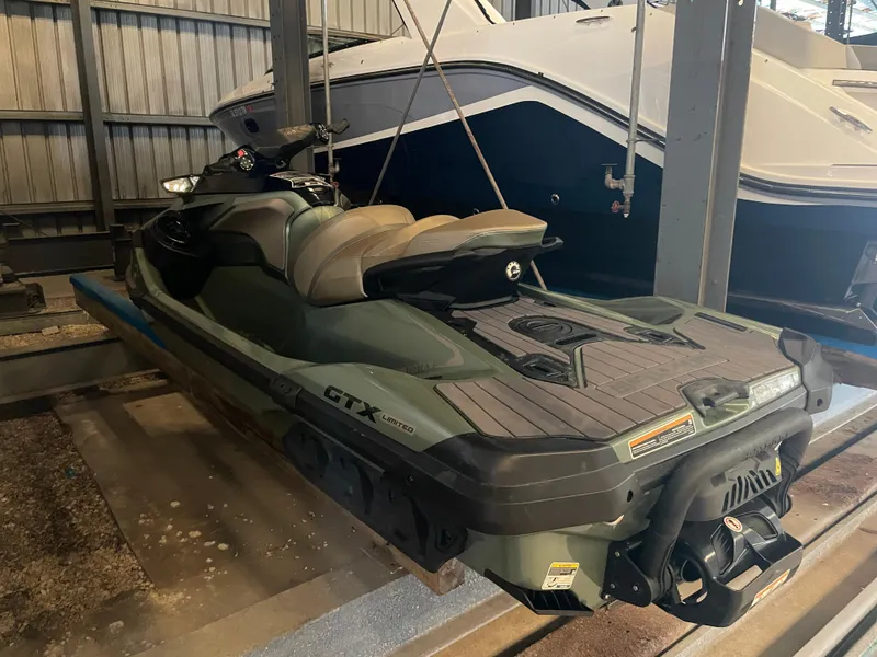 Slide: The Image of 2023 Sea-Doo GTX Limited 300 jet ski in storage, showcasing sleek design and features. - 13